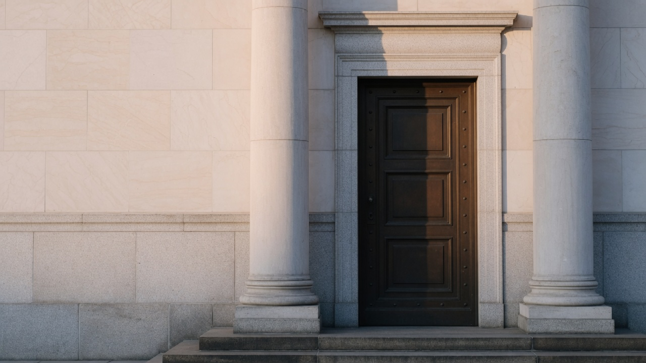 AI-generated editorial image: An unbranded institutional financial vault entrance and clean stone architectural columns with soft natural daylight