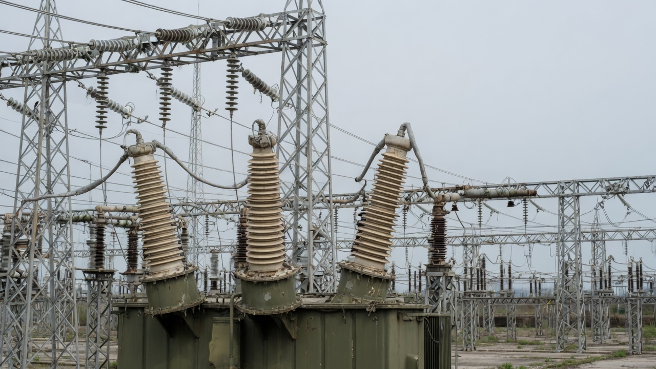 AI-generated editorial image: High-voltage electrical substation transmission equipment in industrial yard
